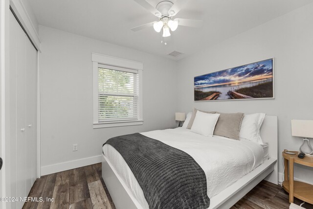 bedroom with a closet, ceiling fan, and dark hardwood / wood-style floors