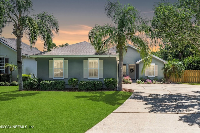 ranch-style home featuring a yard