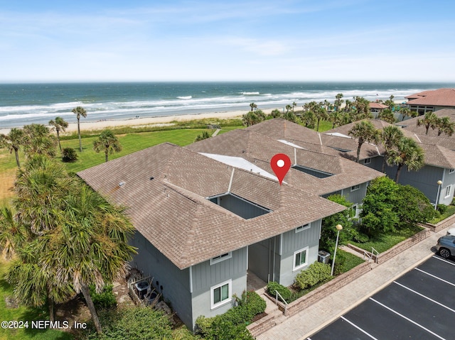 bird's eye view with a water view and a beach view