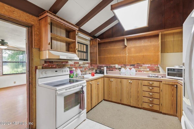 kitchen with lofted ceiling with beams, white appliances, sink, ceiling fan, and light colored carpet