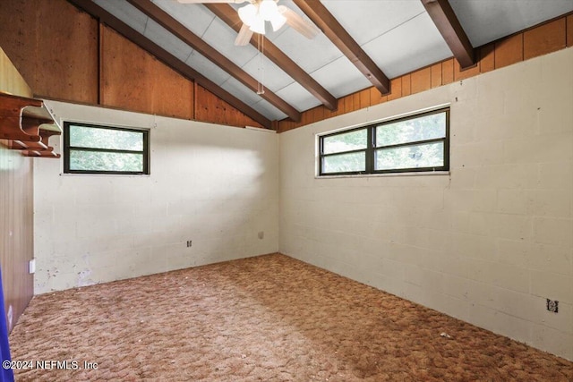 unfurnished room featuring carpet flooring, ceiling fan, and lofted ceiling with beams