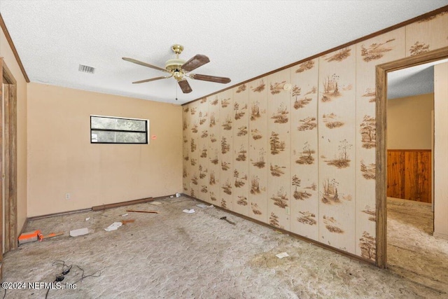 spare room featuring a textured ceiling, carpet floors, and ceiling fan