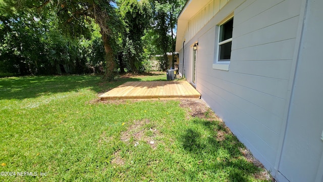 view of yard featuring a wooden deck and central AC