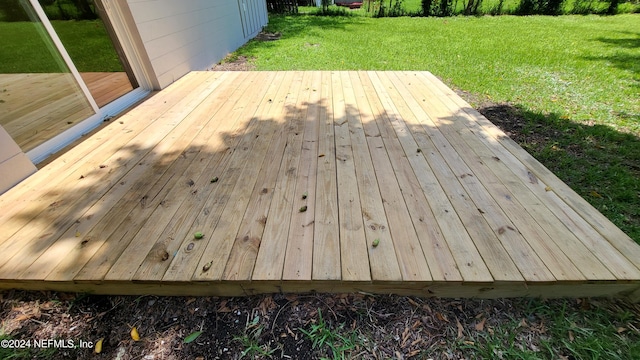 wooden deck with a lawn