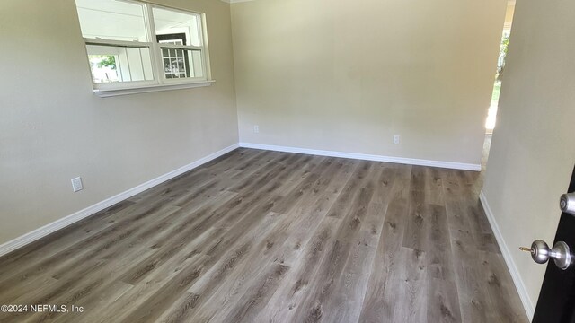 unfurnished room with hardwood / wood-style floors