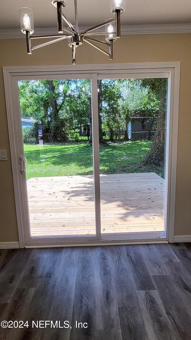 doorway to outside featuring dark hardwood / wood-style floors and crown molding