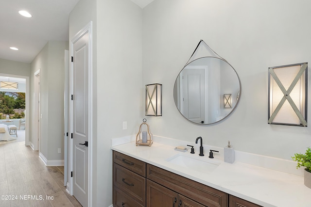 bathroom with hardwood / wood-style flooring and vanity