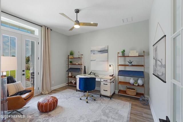 office space featuring ceiling fan, light hardwood / wood-style floors, a textured ceiling, and french doors