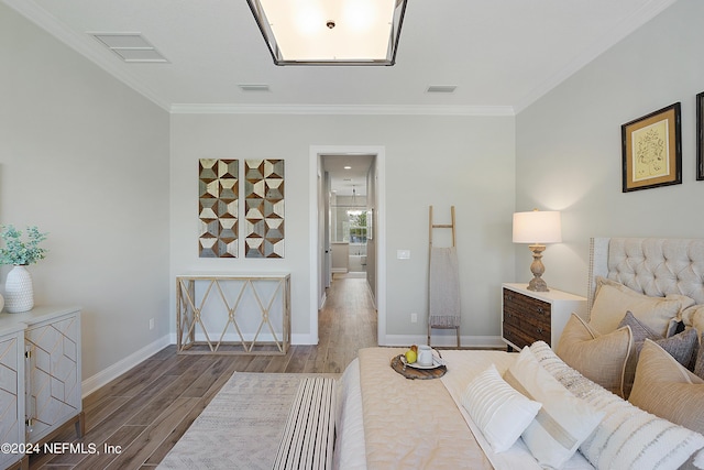 bedroom with hardwood / wood-style flooring and ornamental molding