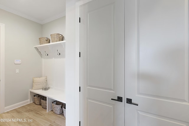 mudroom featuring ornamental molding and light hardwood / wood-style flooring