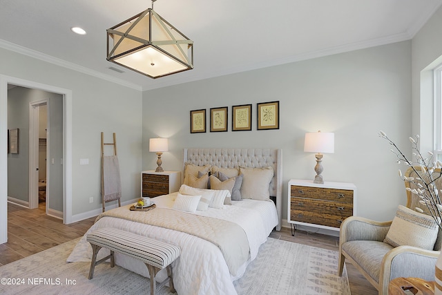 bedroom featuring wood-type flooring and ornamental molding