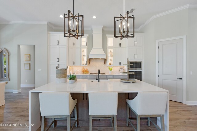 kitchen with a breakfast bar, a spacious island, and light hardwood / wood-style flooring