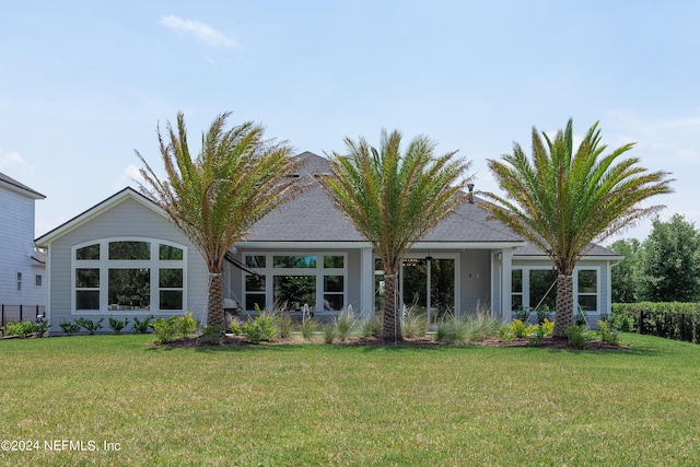 rear view of property featuring a yard