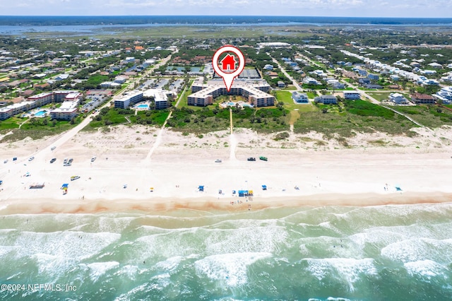 birds eye view of property with a water view and a view of the beach