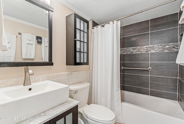 full bathroom with sink, toilet, ornamental molding, tile walls, and shower / tub combo with curtain