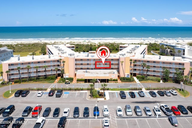 bird's eye view featuring a water view and a beach view