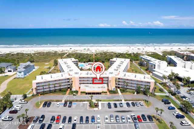 aerial view with a water view and a view of the beach