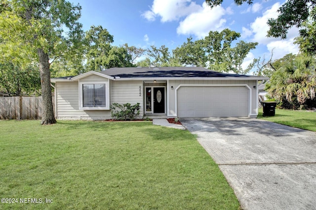 ranch-style house with a front yard and a garage