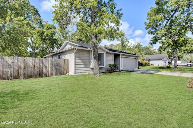 single story home featuring a front lawn and a garage