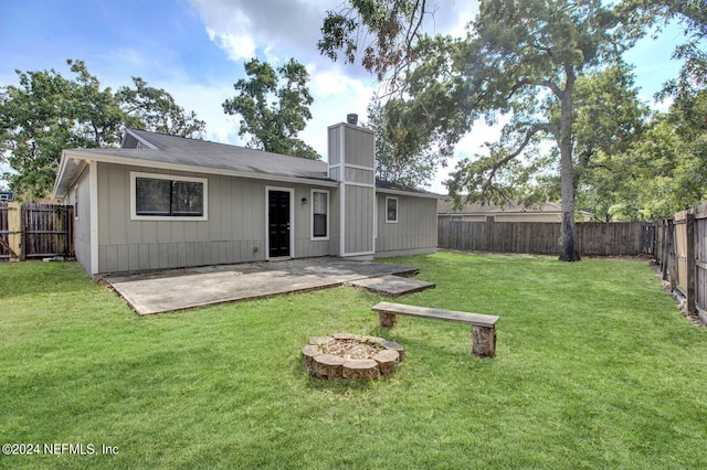 back of property with a yard and a patio area