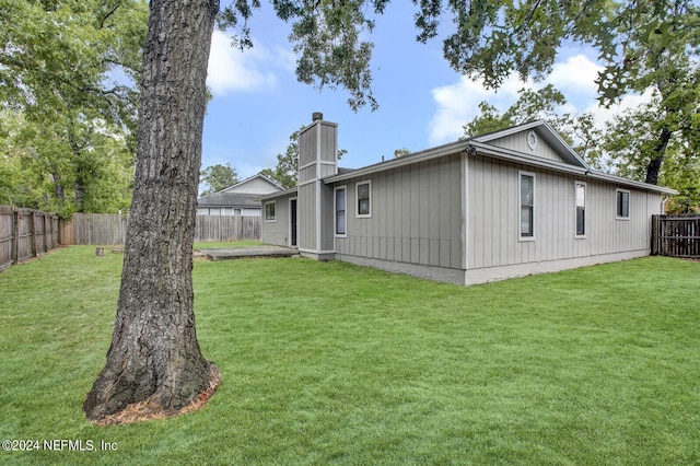 back of house with a yard