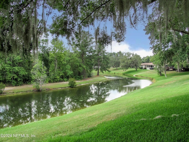 surrounding community featuring a yard and a water view