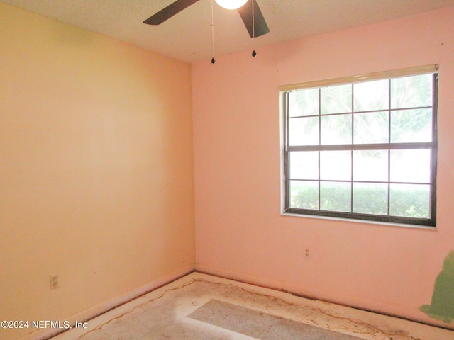 empty room with concrete flooring and ceiling fan