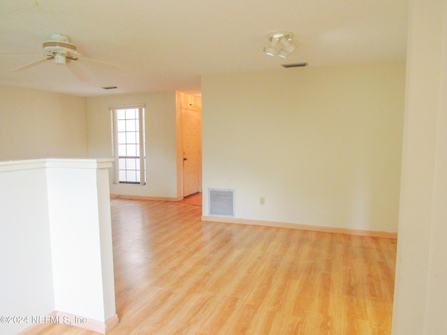 unfurnished room featuring ceiling fan and light wood-type flooring