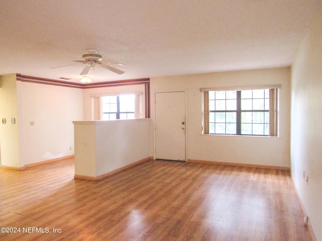 empty room featuring wood-type flooring and ceiling fan