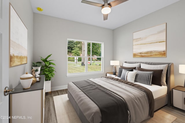 bedroom featuring light wood-type flooring, ceiling fan, and baseboards