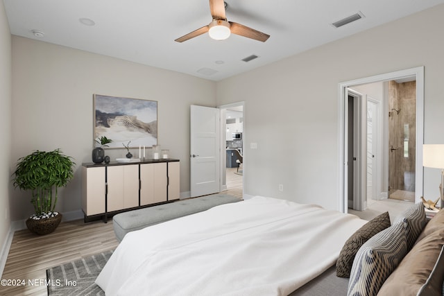 bedroom featuring light hardwood / wood-style flooring, connected bathroom, and ceiling fan