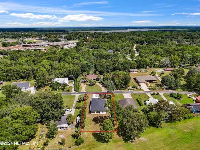 birds eye view of property with a forest view