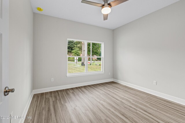 empty room with ceiling fan and hardwood / wood-style flooring