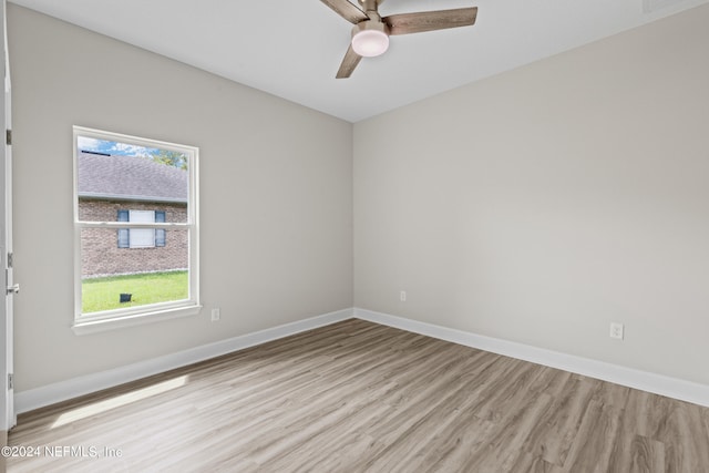 unfurnished room featuring a ceiling fan, baseboards, and wood finished floors