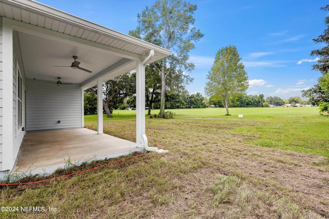 view of yard featuring a ceiling fan and a patio