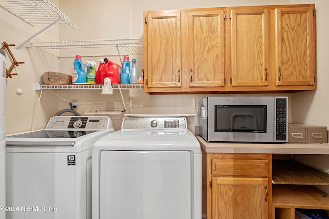 washroom featuring washer and dryer and cabinet space