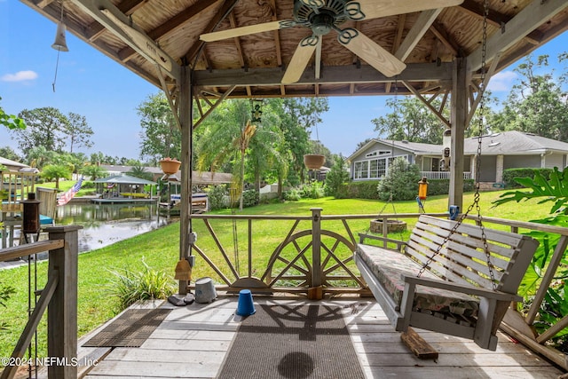 view of patio with a water view, a boat dock, and a gazebo