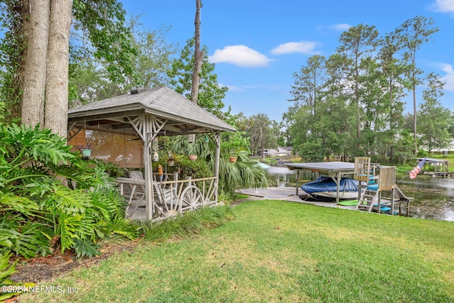 dock area with a gazebo, a lawn, and a water view