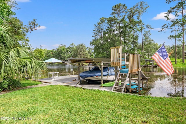 view of dock with a water view and a lawn