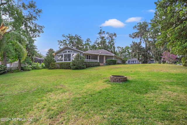 view of yard featuring an outdoor fire pit