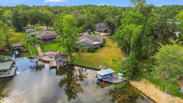 drone / aerial view featuring a water view and a wooded view