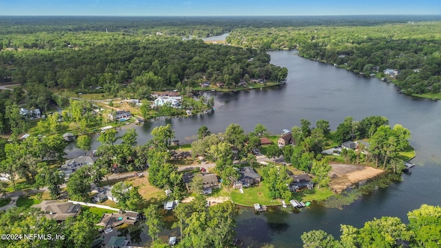 drone / aerial view featuring a water view and a forest view