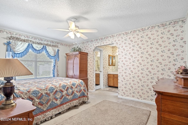 bedroom with light carpet, wallpapered walls, baseboards, ceiling fan, and a textured ceiling