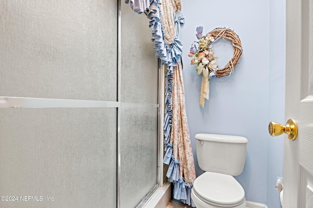 full bathroom with toilet and a shower stall