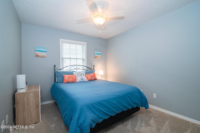 bedroom with carpet, a textured ceiling, and ceiling fan