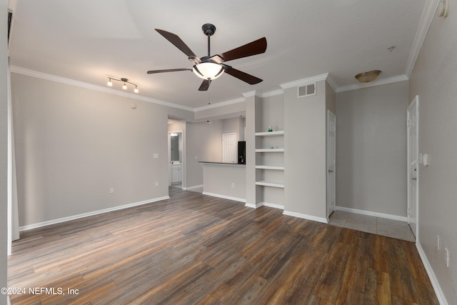 spare room with ornamental molding, dark wood-type flooring, ceiling fan, and rail lighting