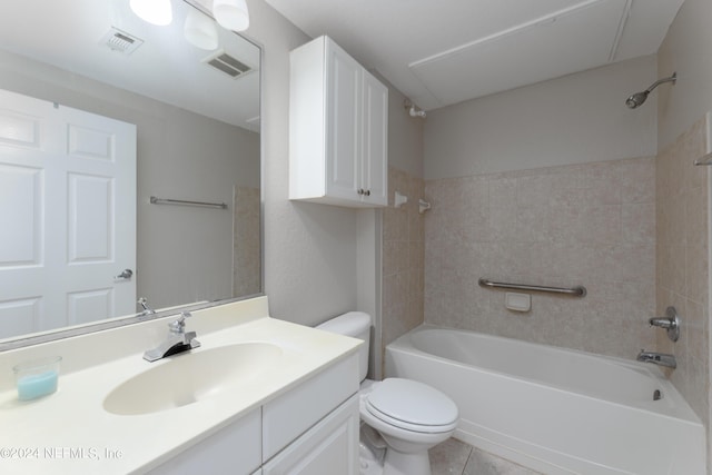 full bathroom featuring tile flooring, toilet, vanity, and tiled shower / bath