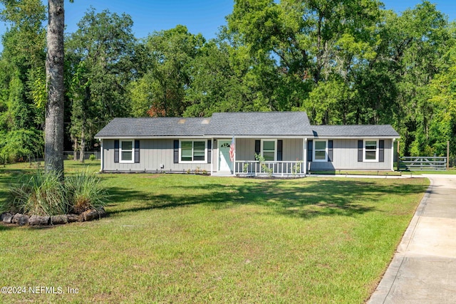 ranch-style home with a porch and a front yard