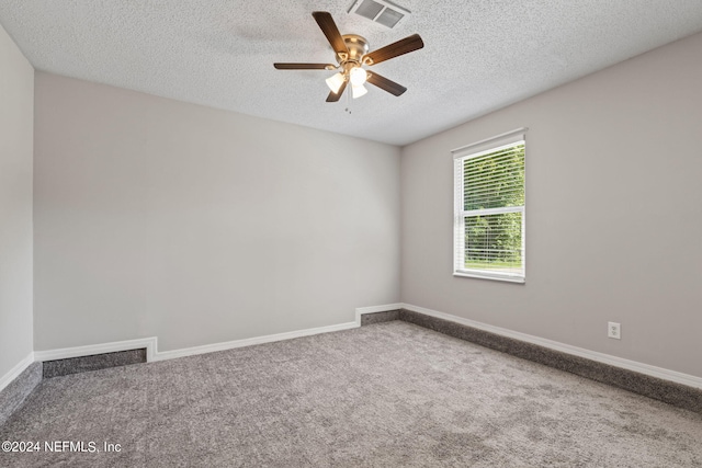 unfurnished room featuring ceiling fan, carpet floors, and a textured ceiling