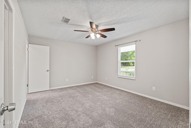 carpeted empty room featuring ceiling fan and a textured ceiling